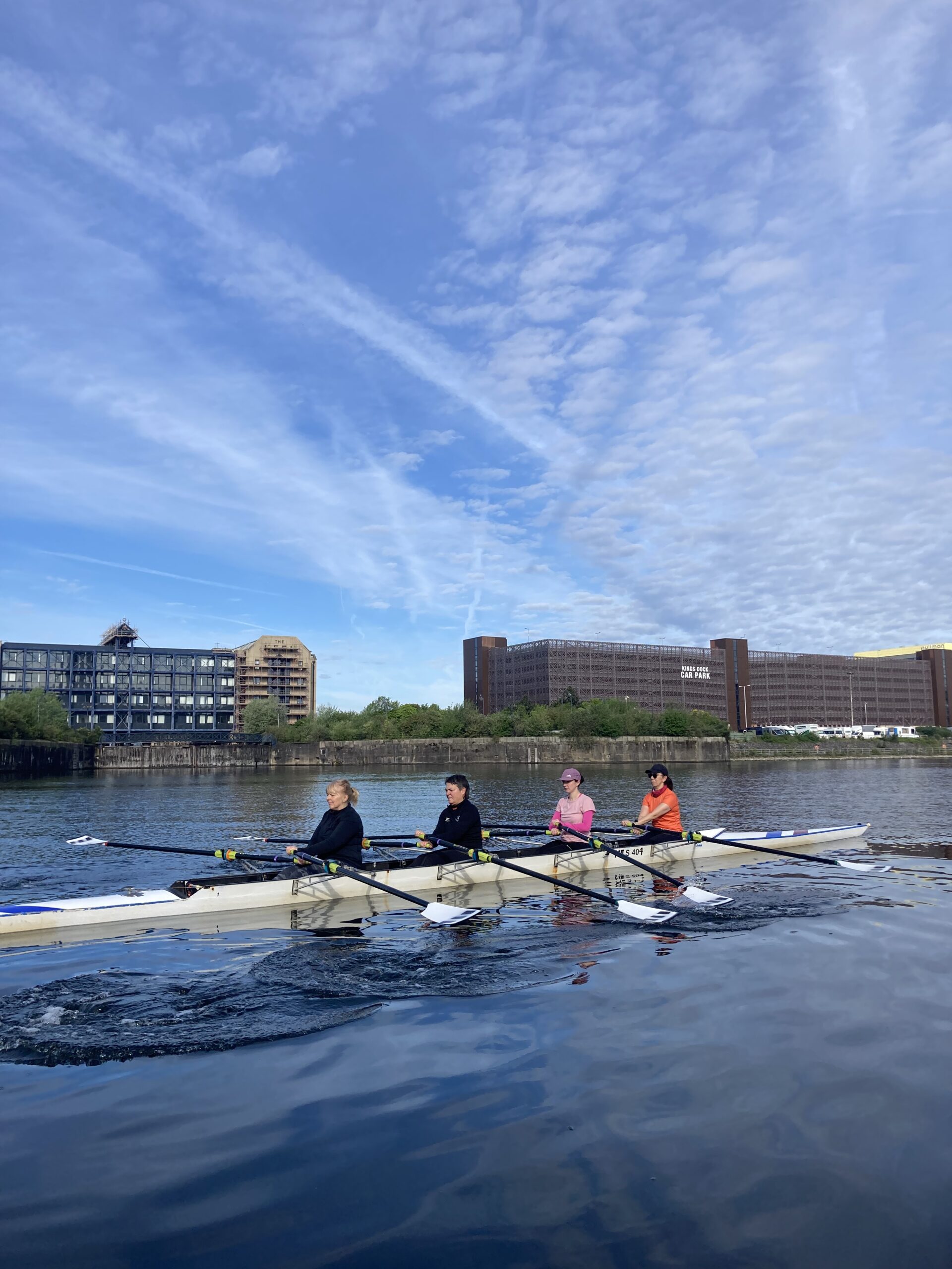Women's Masters Squad in a 4x rowing on the Liverpool Waterfront.