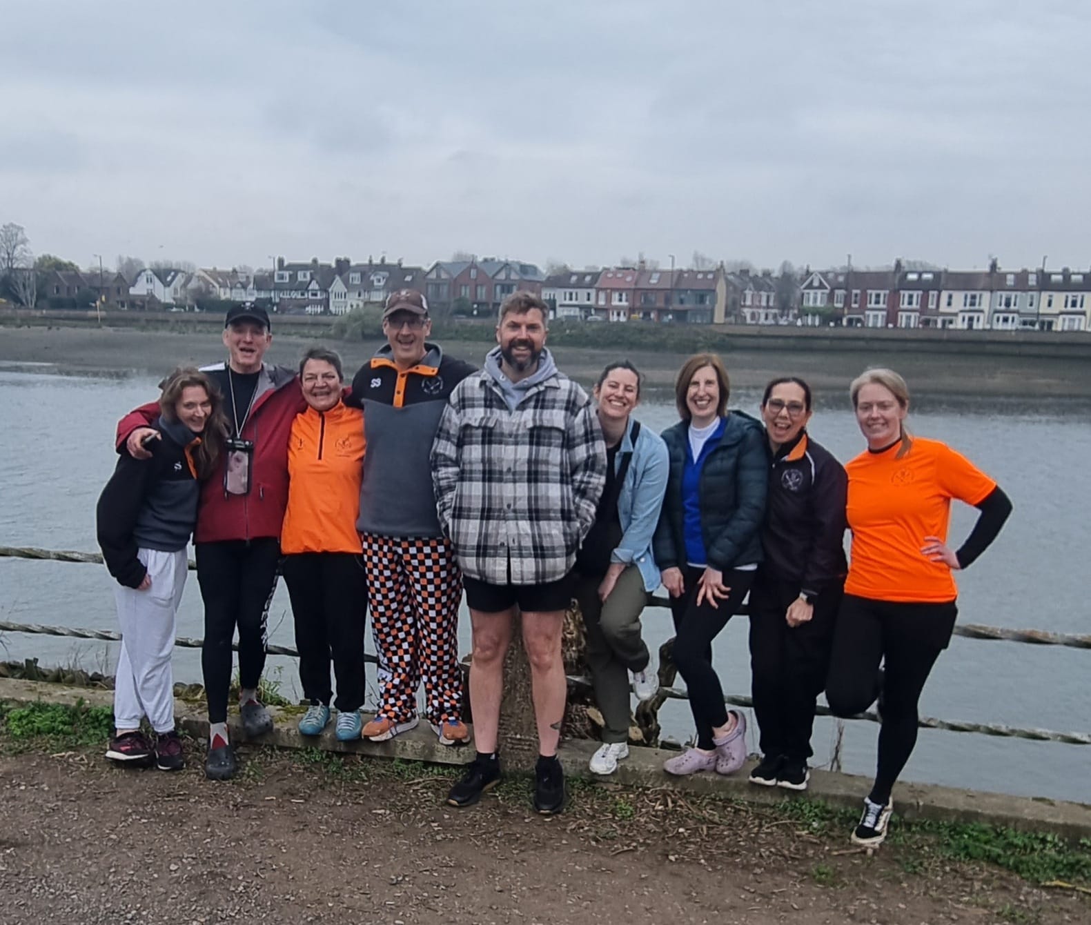 Master's Squad together smiling by a river.