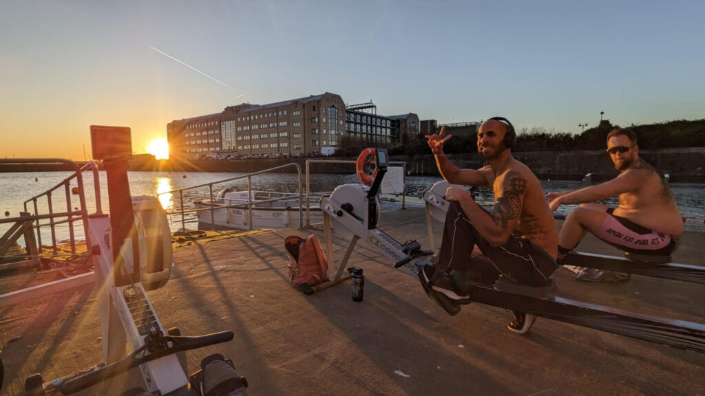 Two of the Men's Squad on rowing machines (ergs) during a land session.