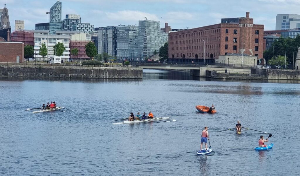 Members of Mersey Rowing Club rowing on Queen's Dock in Liverpool